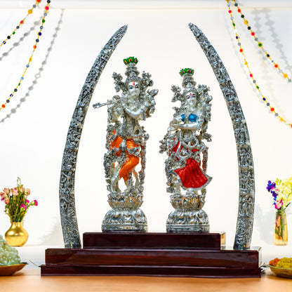 999 Silver Royal Radha Krishna Idol with Carved Tusks on Wooden Mandap Base